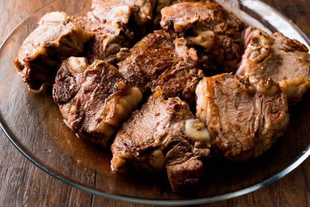 istock Lamb Meats in glass bowl on dark wooden surface. 885781536