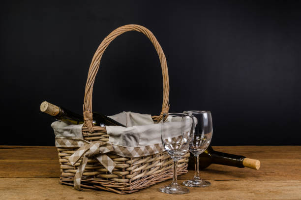 istock red wine bottles on wicker basket on wooden table 885786488