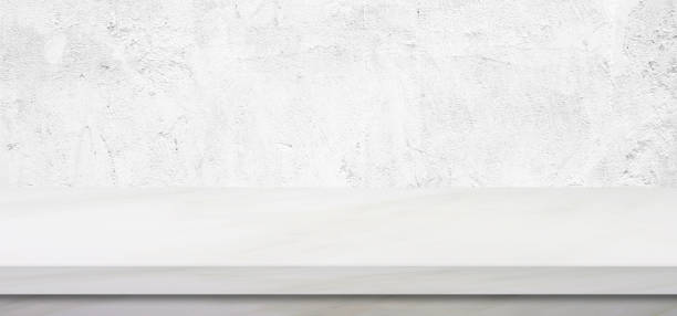 istock Empty white marble table over green cement wall background, banner, product display montage 885789274
