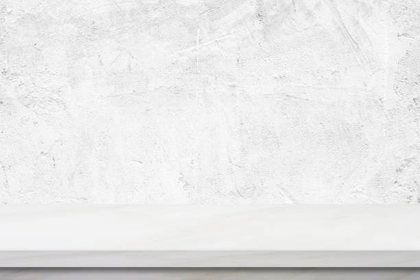 istock Empty white marble table over white cement wall background, banner, product display montage 885789286