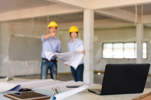 istock Several of construction design tools with Abstract blurred engineers reading blueprint and discuss about construction project 885796764