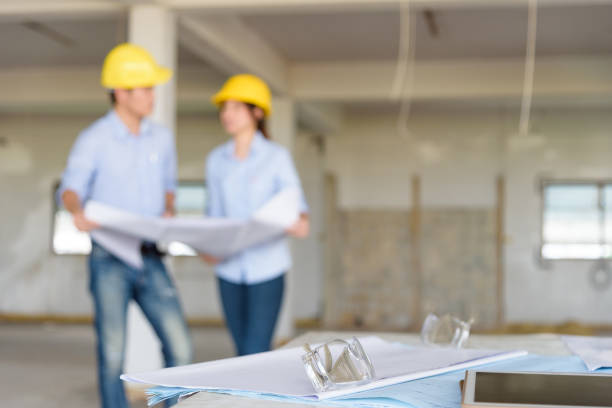 istock Several of construction design tools with Abstract blurred engineers reading blueprint and discuss about construction project 885796912