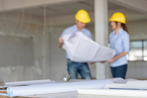 istock Several of construction design tools with Abstract blurred engineers reading blueprint and discuss about construction project 885796928