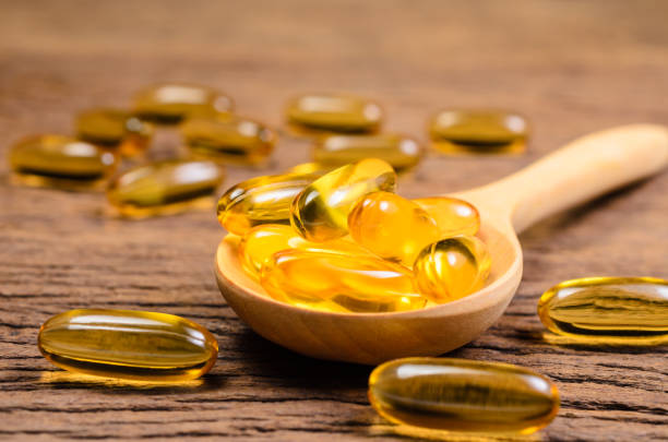 istock fish oil in wooden spoon 885799434