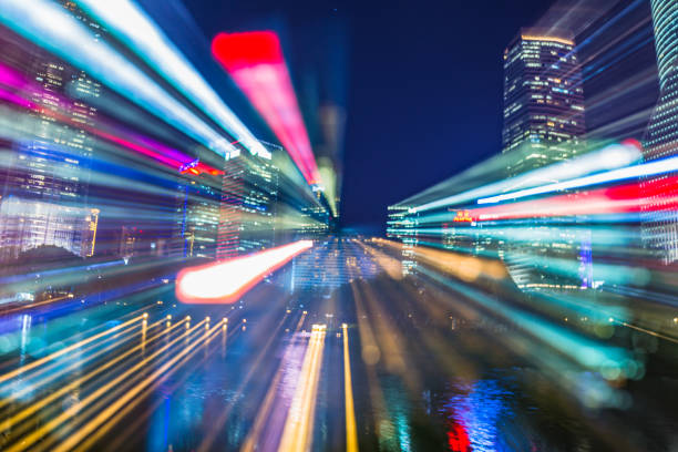 istock Blurred skyscrapers at night with bokeh light trails 885822318