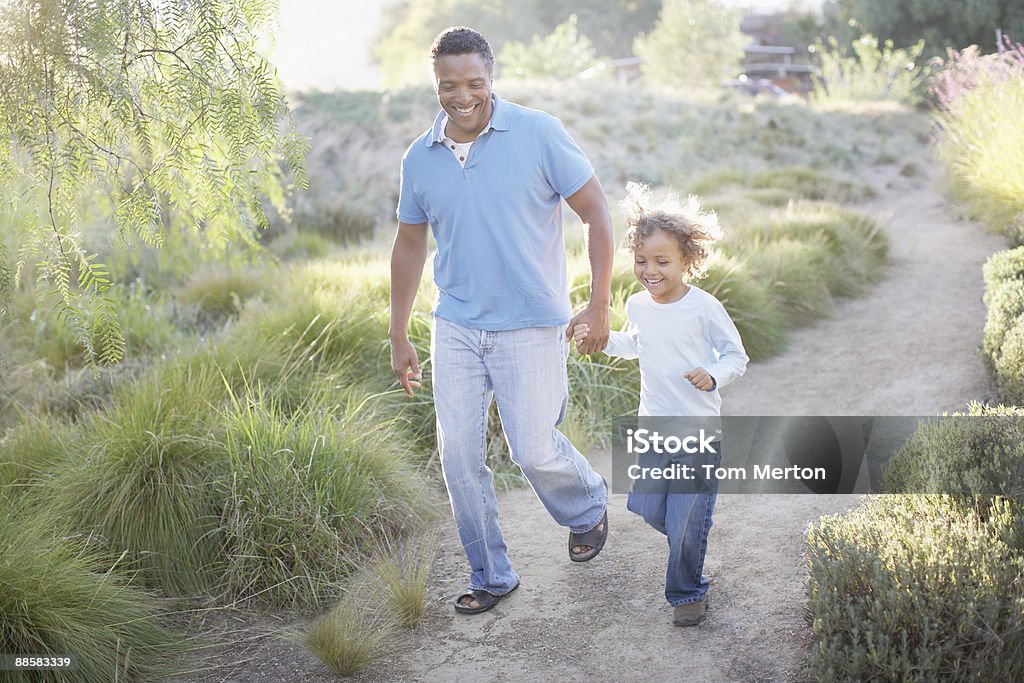 Man walking with son on trail  Public Park Stock Photo