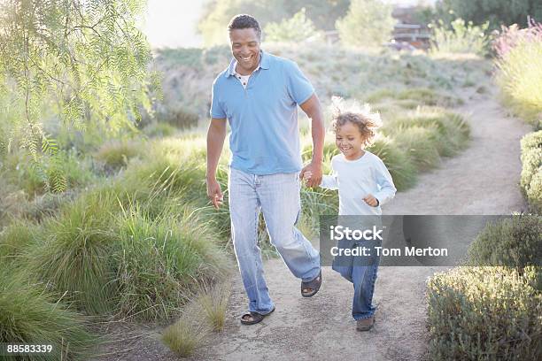 Man Walking With Son On Trail Stock Photo - Download Image Now - Public Park, Walking, Mature Men