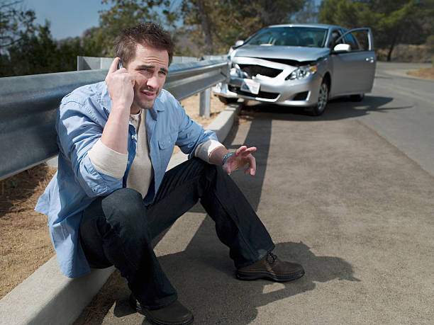 Man with crashed car calling for roadside assistance,  traffic accident photos stock pictures, royalty-free photos & images