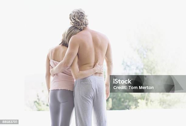 Couple Hugging Outdoors Stock Photo - Download Image Now - Men, Modern, Rear View