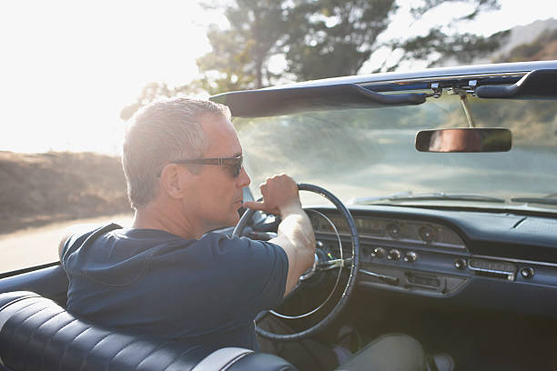 Man driving classic convertible car  collectors car stock pictures, royalty-free photos & images