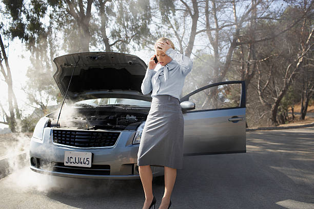 Woman calling for roadside assistance  overheated stock pictures, royalty-free photos & images