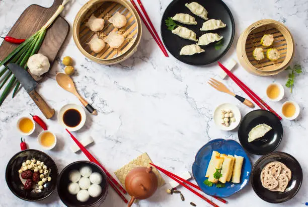 Flat lay Chinese new year reunion dinner food and drink still life. Texts appear in image: Prosperity, spring, good luck.