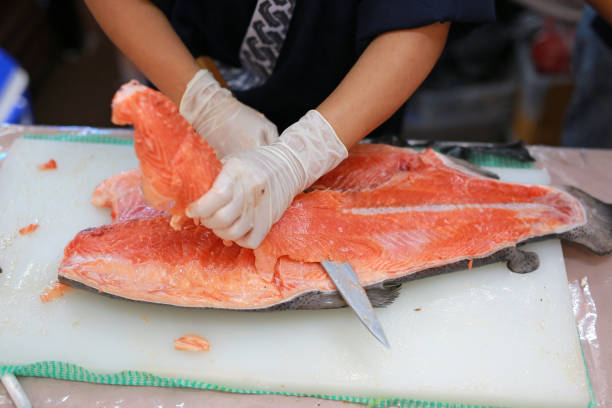 istock The chef cuts the salmon on the table. 885851634