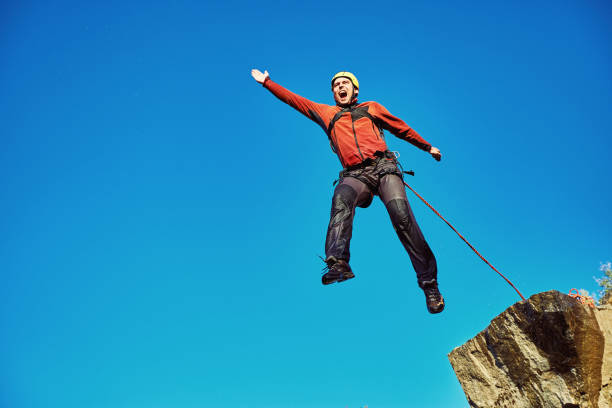 istock Jump off the cliff with a rope. 885887454