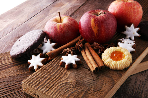 istock christmas cookies, apples, gingerbread and spice on brown background. 885896672