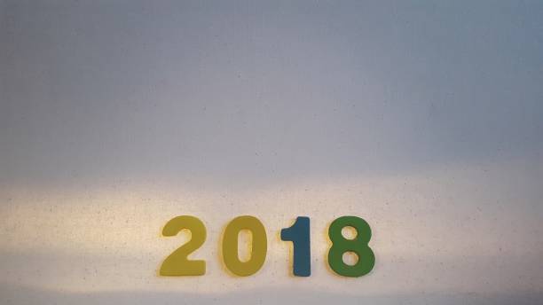 istock Colored figures to form the number 2018 on white canvas 885896896
