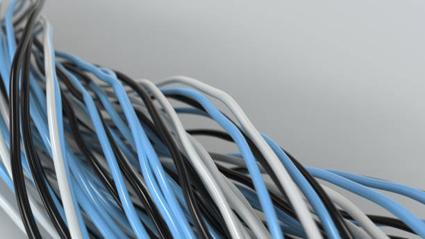 istock Twisted black, white and blue cables and wires on white surface 885900184