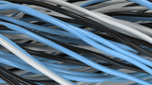 istock Twisted black, white and blue cables and wires on white surface 885902258