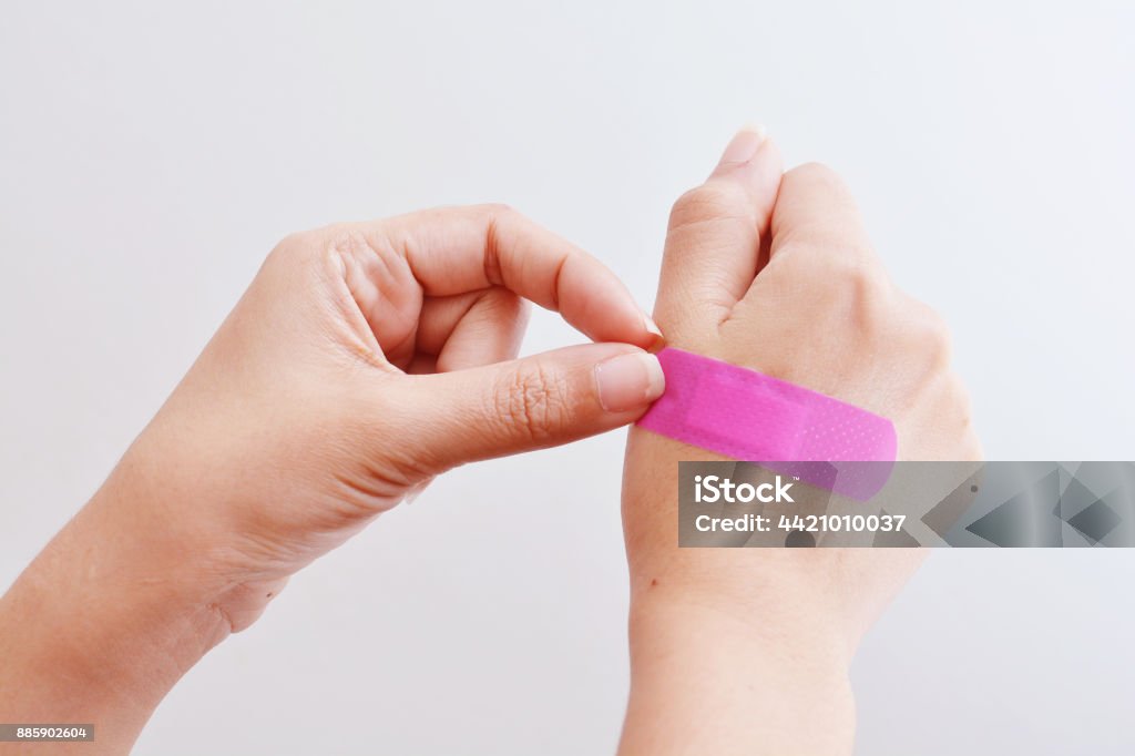 Woman hand with adhesive tape. Adhesive Bandage Stock Photo