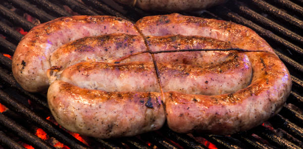 istock Grilling sausages on barbecue grill. 885907926