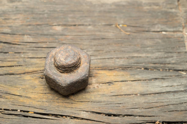 istock Nut bolt on old wooden plank 885907986