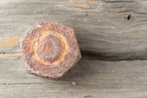 istock Bolt Nut on Old wooden plank 885908186