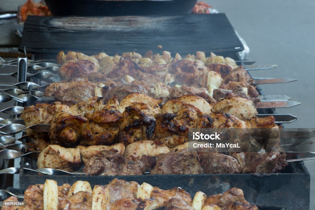 Marinated shashlik preparing on a barbecue grill over charcoal. Marinated shashlik preparing on a barbecue grill over charcoal Baked Beans Stock Photo