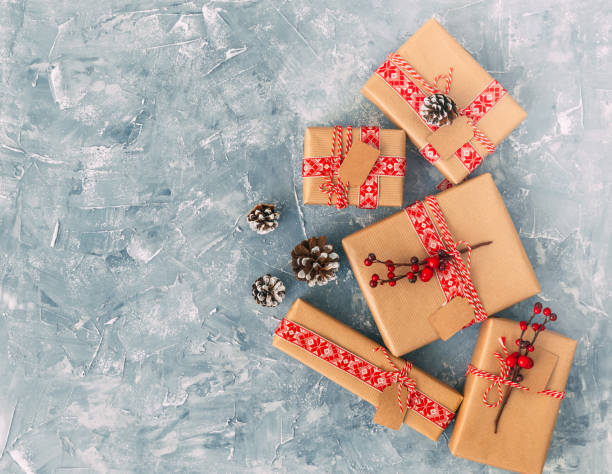 istock Christmas present. Flat lay composition. Wrapped gift boxes over vintage background 885920550