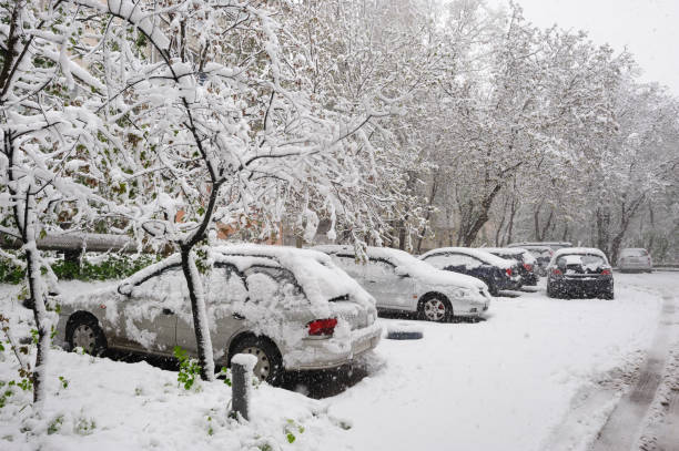 istock snow covered cars at winter parking 885923056