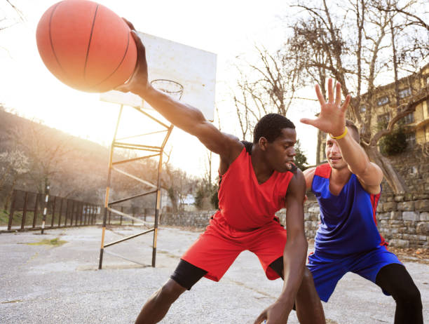 istock Basketball players playing outdoors on court 885926078