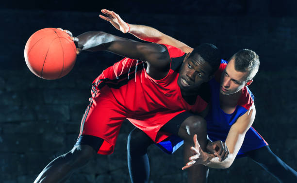 istock Basketball players playing outdoors on court 885926084
