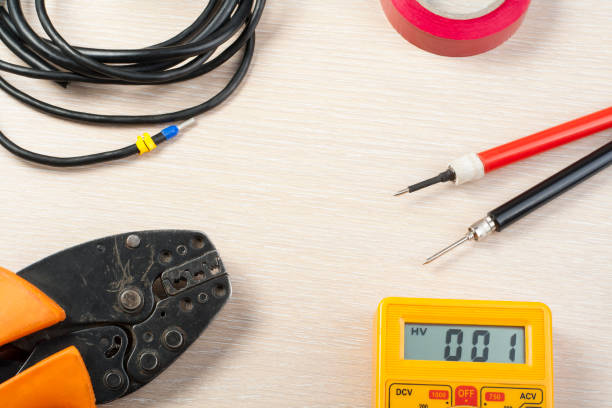 istock Set of electrical tools on wooden background. Accessories for engineering work, energy concept.Copy space for text. 885926236