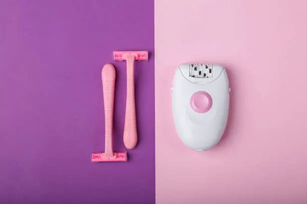 Photo of Epilator, disposable razor, on a pink background, space for text.