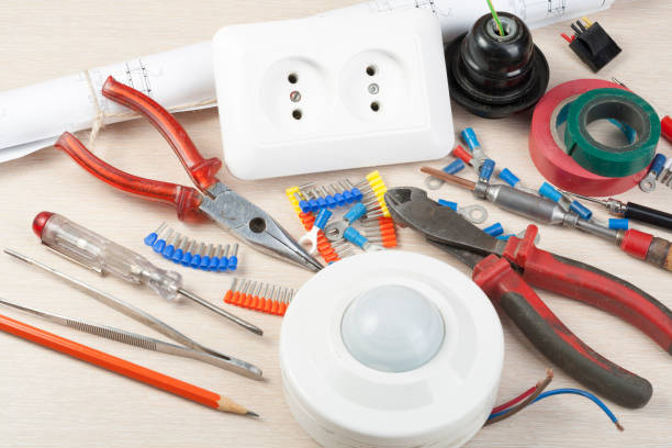 istock Set of electrical tool on wooden background. Accessories for engineering work, energy concept. 885932062