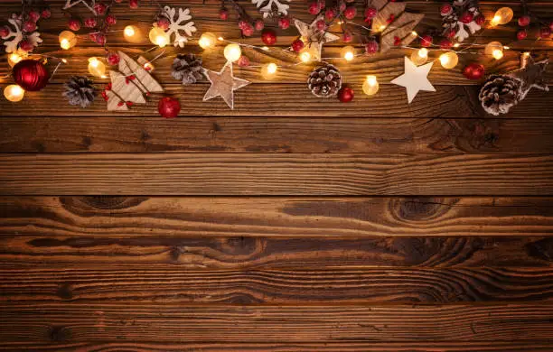 Christmas background with wooden decorations and spot lights. Free space for text. Celebration and decorative design.