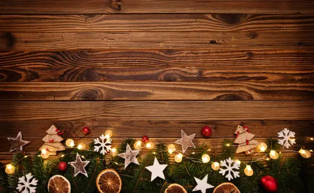 Christmas background with wooden decorations and spot lights. Free space for text. Celebration and decorative design.