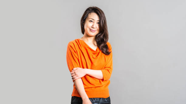 istock Women in orange clothes, studio shoot 885944068