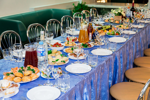 Served tables at the Banquet. Drink, alcohol, delicacies and snacks. Catering. A reception event.