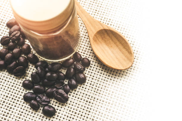 istock Coffee beans glass bottle on sack - Top view 885953582