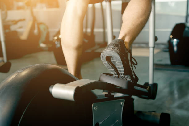 istock Man running in a gym on a treadmill for exercising. 885956150