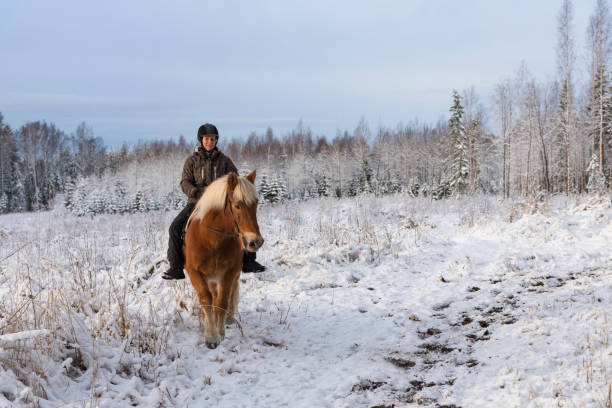 istock Woman horseback riding in winter 885959218