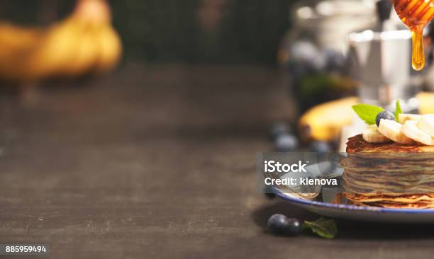 Homemade Pancakes With Fresh Bananas Blueberries And Honey Stock Photo - Download Image Now