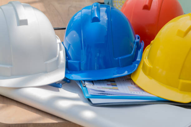 istock White, blue, orange and yellow hat on the table. Safety helmets for technician safety projects are engineers or construction workers. 885965068