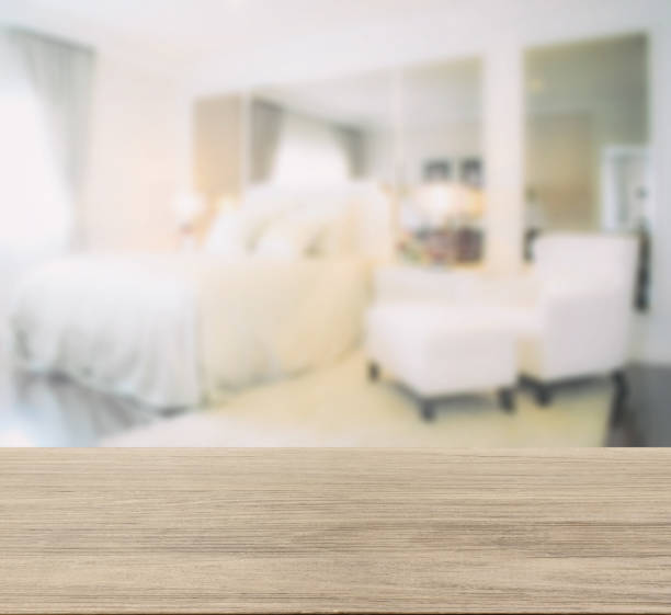 istock wooden table top with blur image of bedroom interior modern styl 885968076