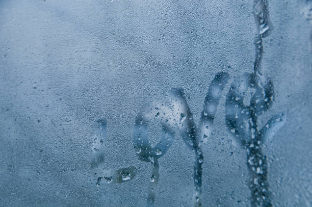 istock Love text draw on droplet window of cold misty morning 885970706