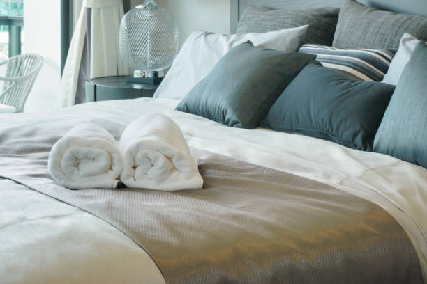 istock White towels on bed in stylish bedroom interior 885971106