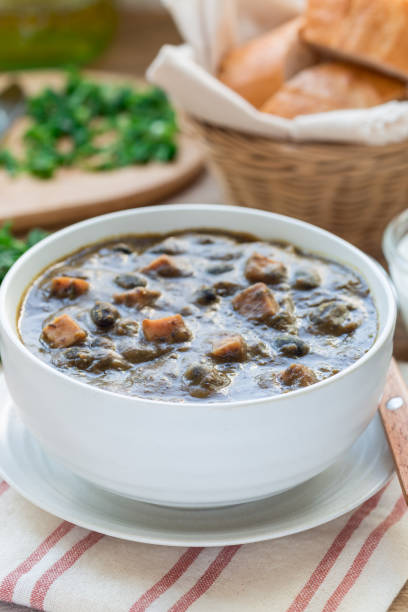 istock Homemade black bean and ham soup in ceramic bowl, vertical 885973776