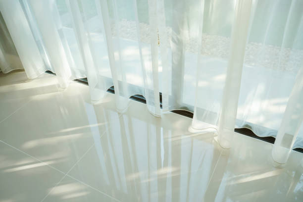istock Beautiful morning light through sheer curtain in bedroom 885973970