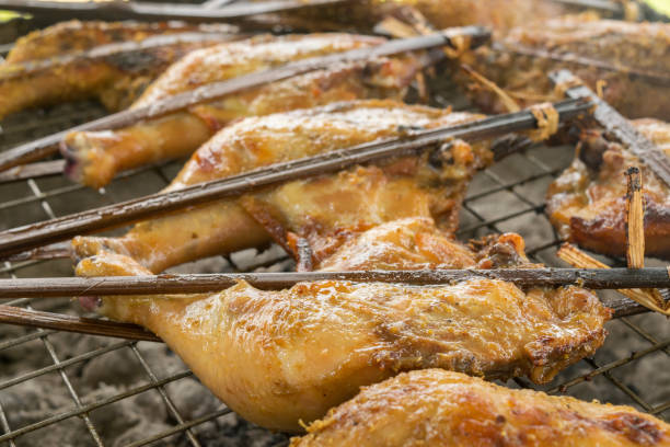 istock Grilled chicken on stove. Roast chicken by using bamboo 885980752