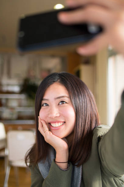 istock Young woman taking selfie picture in cafe 885983696